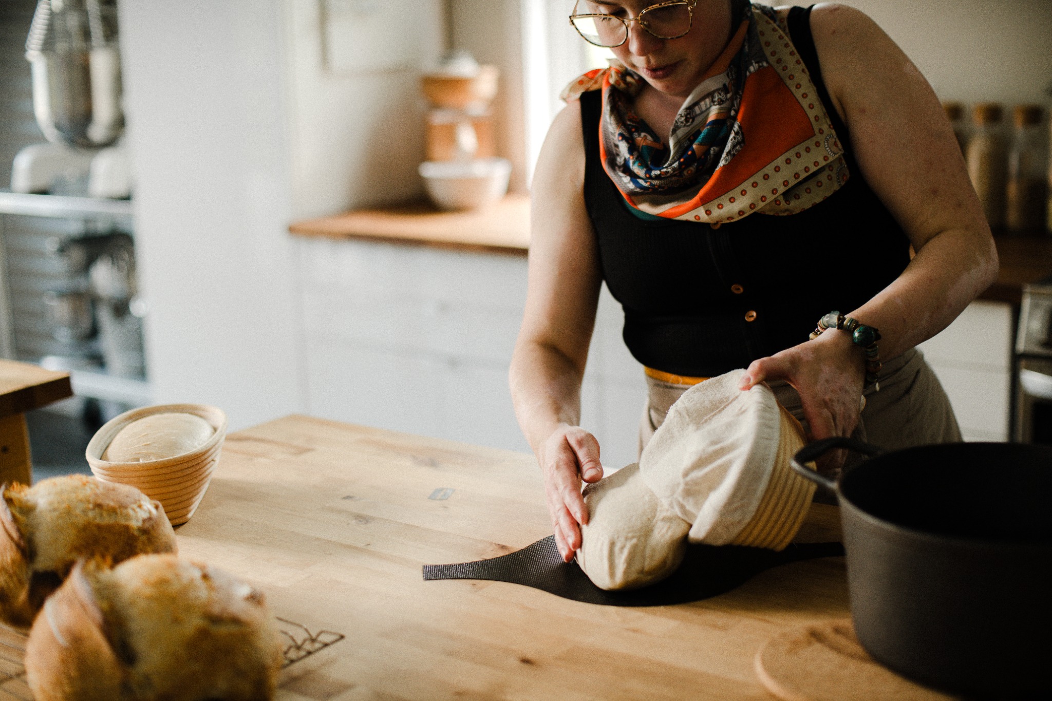 An Ontario artisan baker shaping bread by hand